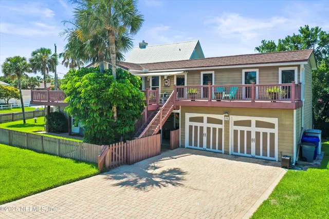 a front view of a house with a yard table and chairs