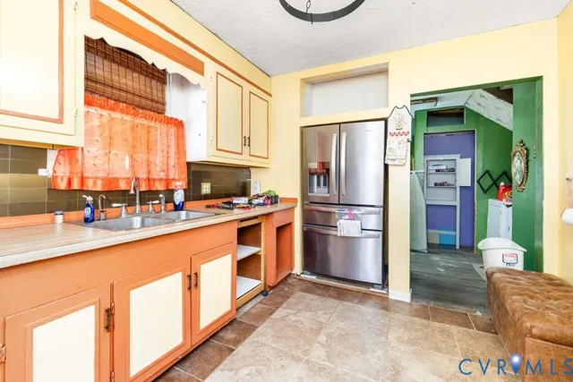 a kitchen with stainless steel appliances a refrigerator and a stove