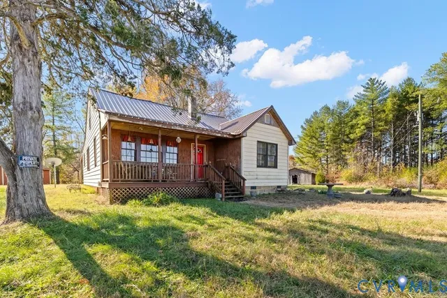 a view of a house with a yard and tree s