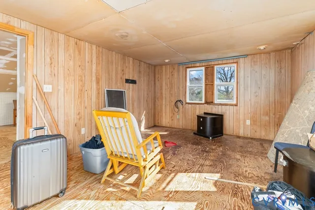 a living room with furniture a fireplace and a floor to ceiling window