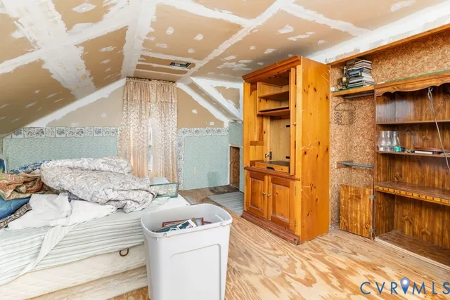 a view of walk in closet and bedroom