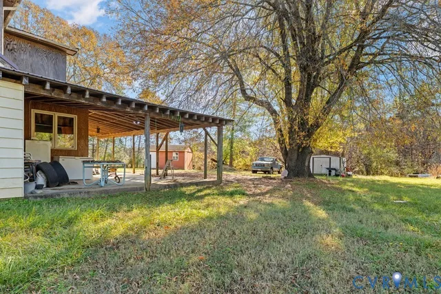 a view of a house with swimming pool and sitting area