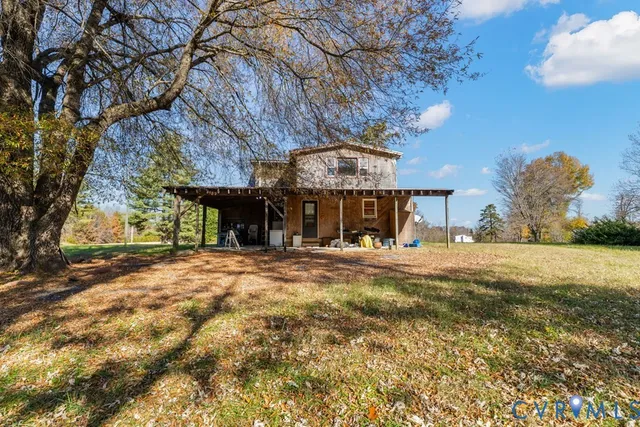 a view of a house with a tree and a yard