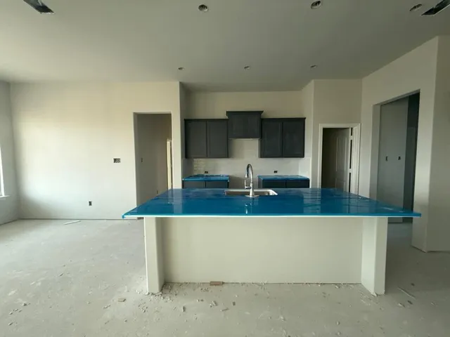 a view of a kitchen with a sink and mirror