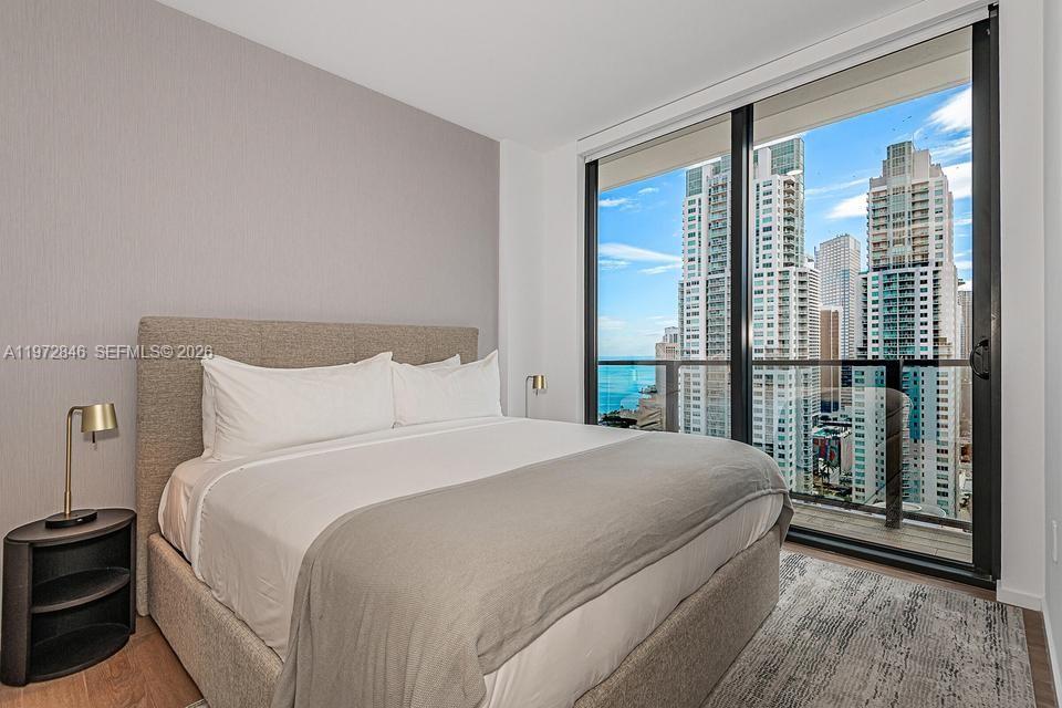 398 Northeast 5th Street, Unit 2418 Miami, FL 33132 - Photo 22 of 34 a bedroom with a large bed and a large window