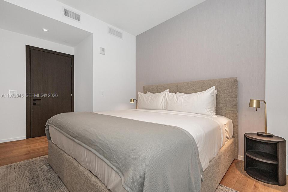 398 Northeast 5th Street, Unit 2418 Miami, FL 33132 - Photo 23 of 34 a bedroom with a bed and with furniture