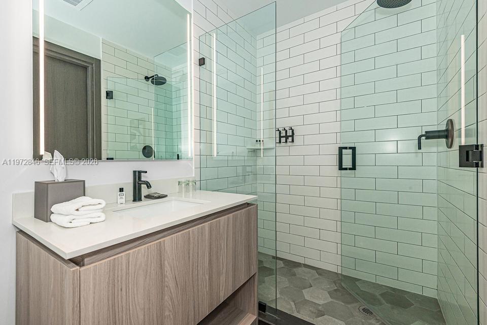 398 Northeast 5th Street, Unit 2418 Miami, FL 33132 - Photo 25 of 34 a bathroom with a sink a toilet and shower