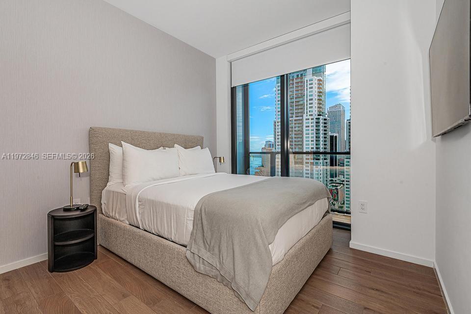 398 Northeast 5th Street, Unit 2418 Miami, FL 33132 - Photo 27 of 34 a bedroom with a bed and a large window