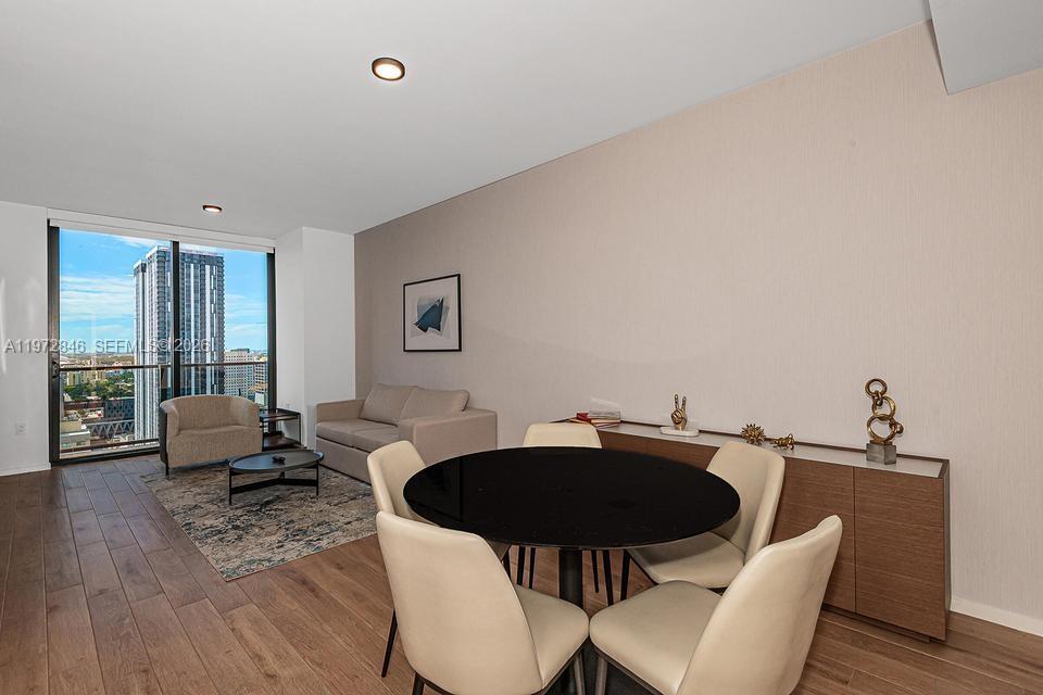 398 Northeast 5th Street, Unit 2418 Miami, FL 33132 - Photo 4 of 34 a view of a dining room with furniture and wooden floor