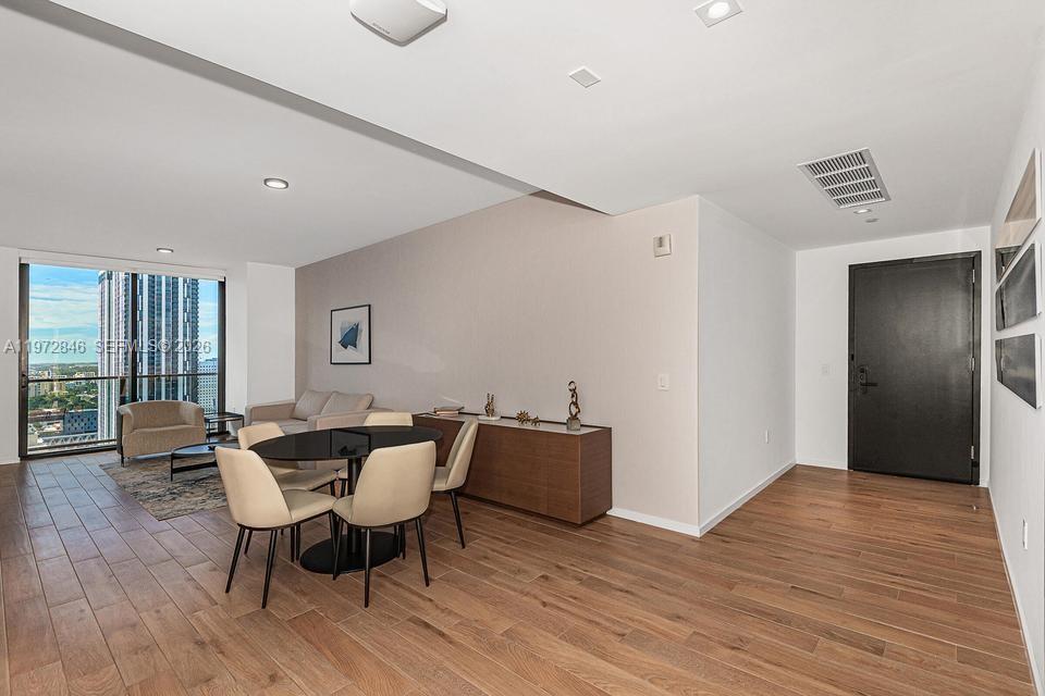 398 Northeast 5th Street, Unit 2418 Miami, FL 33132 - Photo 5 of 34 a dining room with furniture and wooden floor