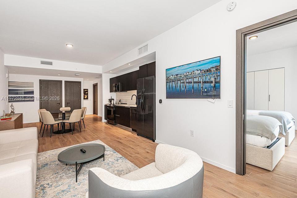 398 Northeast 5th Street, Unit 2418 Miami, FL 33132 - Photo 9 of 34 a living room with furniture and a flat screen tv