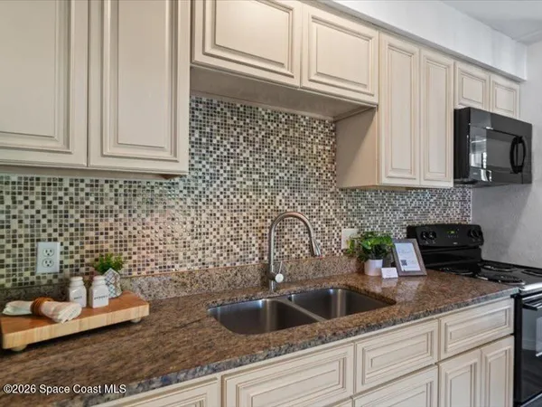 a kitchen with sink and cabinets