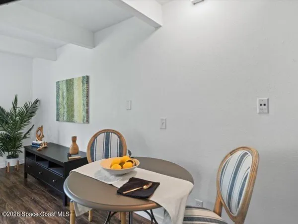 a view of a dining room with furniture and window