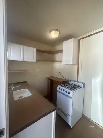 a kitchen that has a lot of cabinets in it