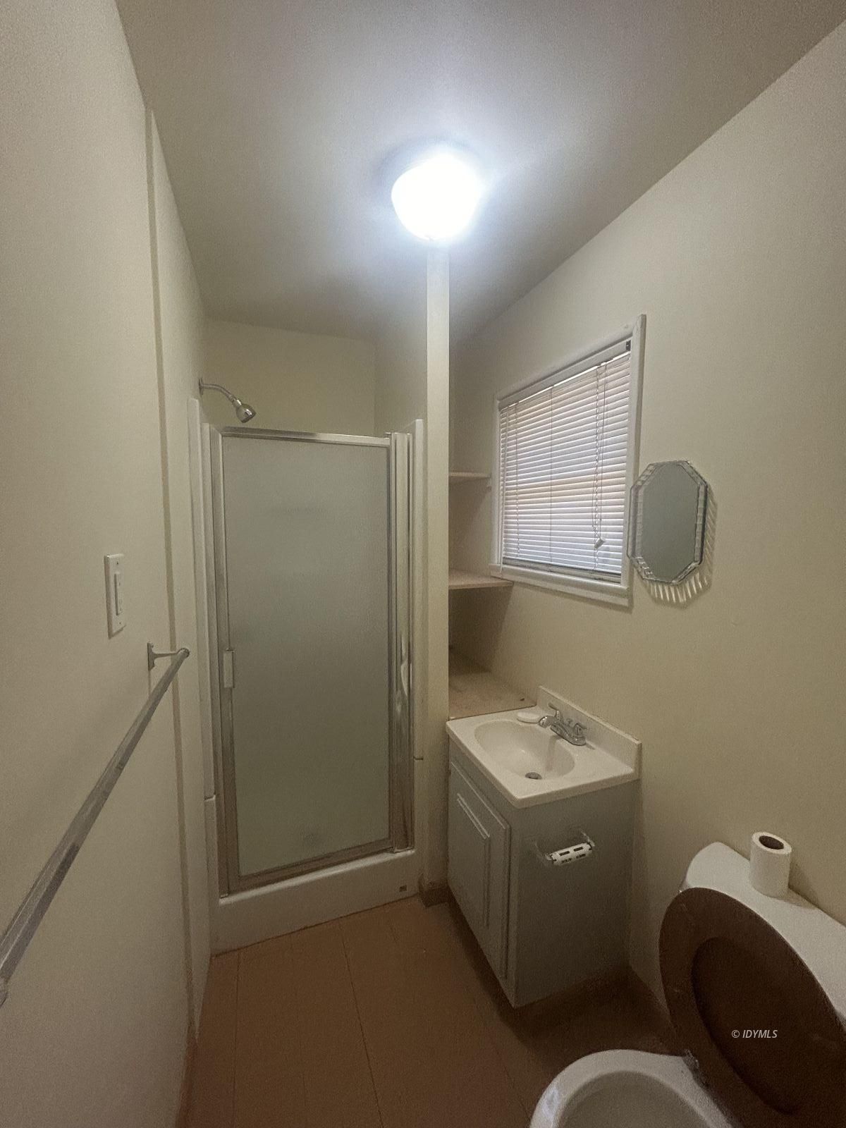 25055 Marion Ridge Drive, Unit 9 Idyllwild, CA 92549 - Photo 7 of 11 a bathroom with a granite countertop sink a toilet and mirror