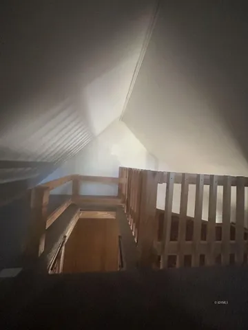 a view of an empty room and a window