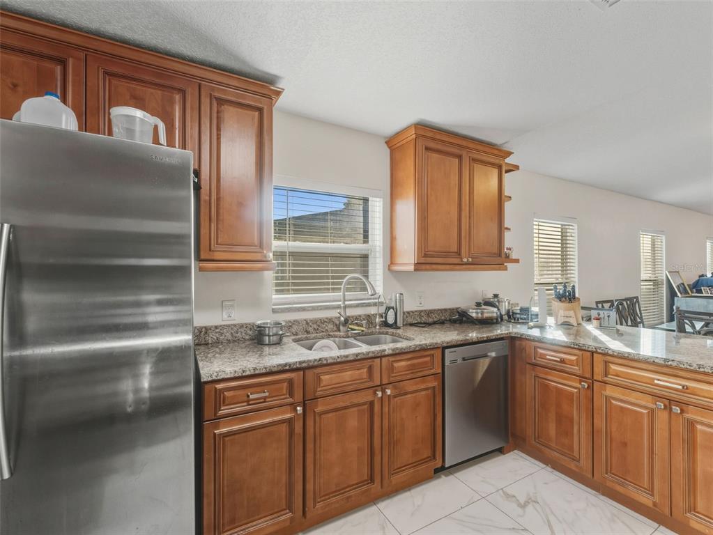 5104 Timberlan Street Tampa, FL 33624 - Photo 11 of 27 a kitchen with a sink stove and cabinets