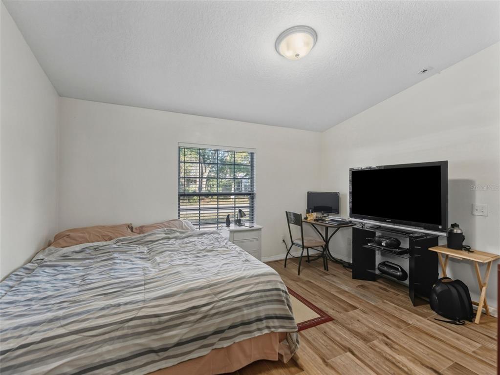 5104 Timberlan Street Tampa, FL 33624 - Photo 13 of 27 a bedroom with a bed and a flat screen tv