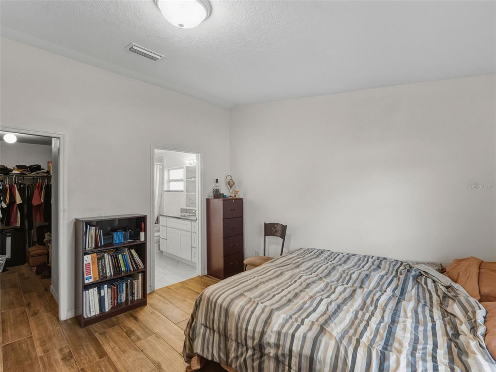 5104 Timberlan Street Tampa, FL 33624 - Photo 14 of 27 a bedroom with a bed and a bookshelf