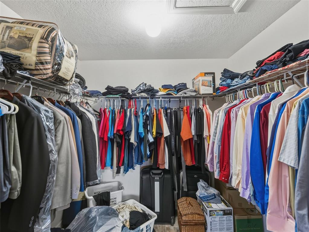 5104 Timberlan Street Tampa, FL 33624 - Photo 16 of 27 a view of walk in closet with clothes and shoes