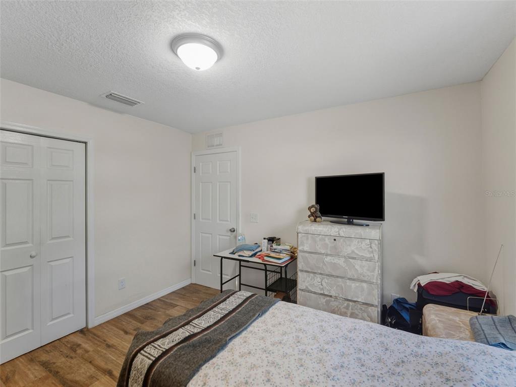 5104 Timberlan Street Tampa, FL 33624 - Photo 18 of 27 a bedroom with a bed and a flat screen tv