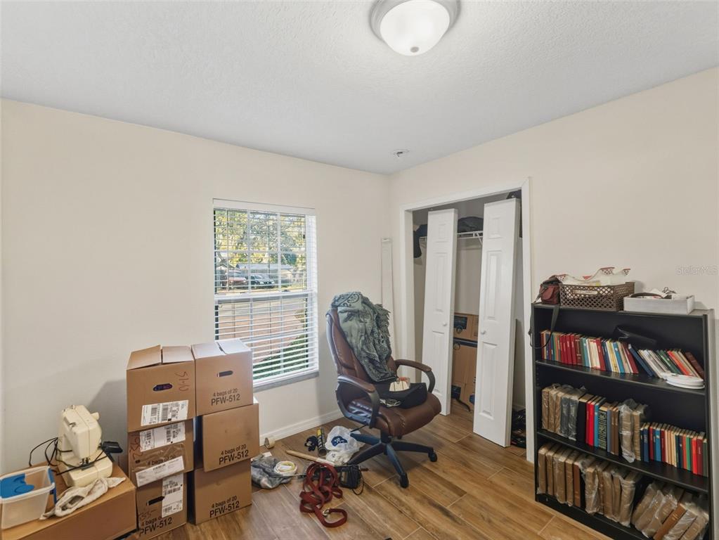 5104 Timberlan Street Tampa, FL 33624 - Photo 20 of 27 a view of a workspace with furniture and a book shelf