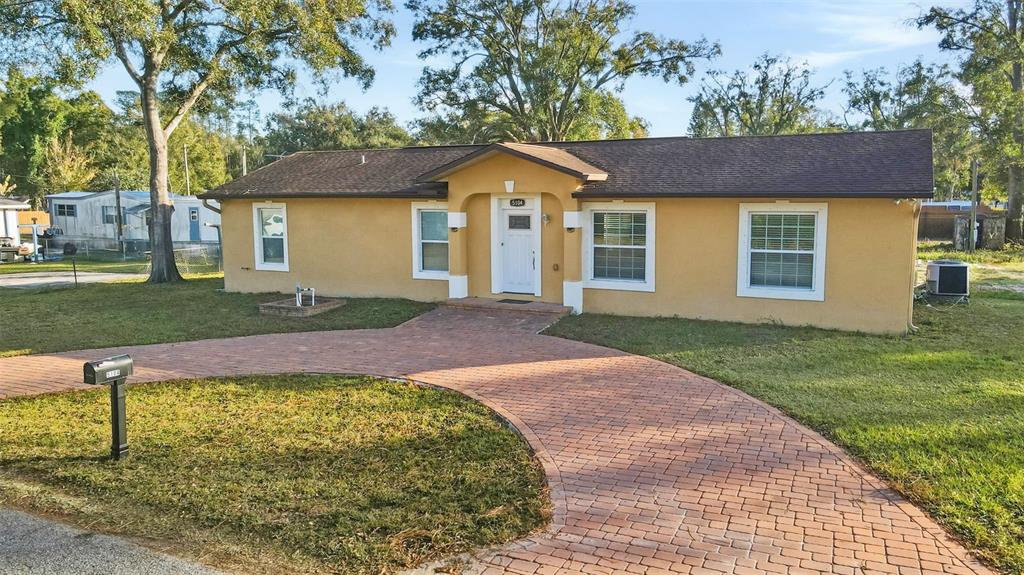 5104 Timberlan Street Tampa, FL 33624 - Photo 23 of 27 a front view of a house with a yard