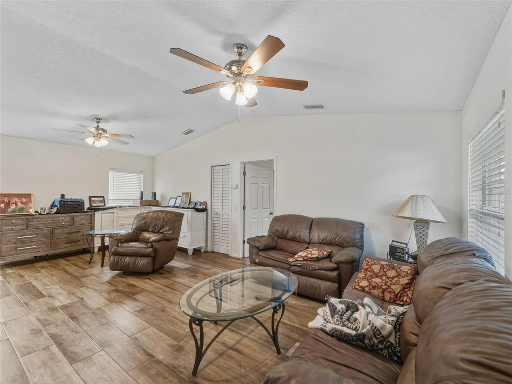 5104 Timberlan Street Tampa, FL 33624 - Photo 5 of 27 a living room with furniture and a chandelier