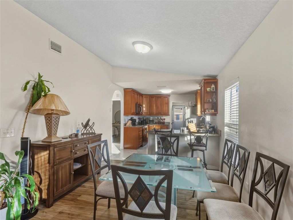 5104 Timberlan Street Tampa, FL 33624 - Photo 8 of 27 a view of a dining room with furniture window and wooden floor