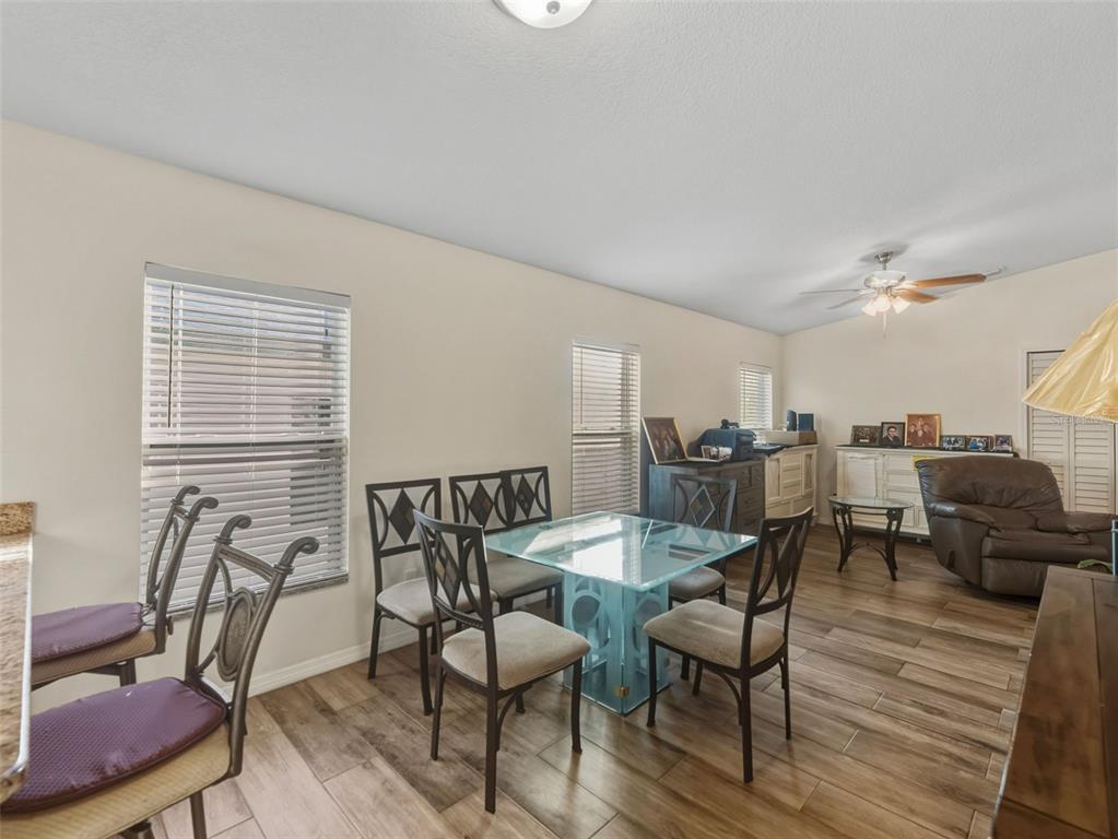 5104 Timberlan Street Tampa, FL 33624 - Photo 9 of 27 a view of a dining room with furniture and wooden floor