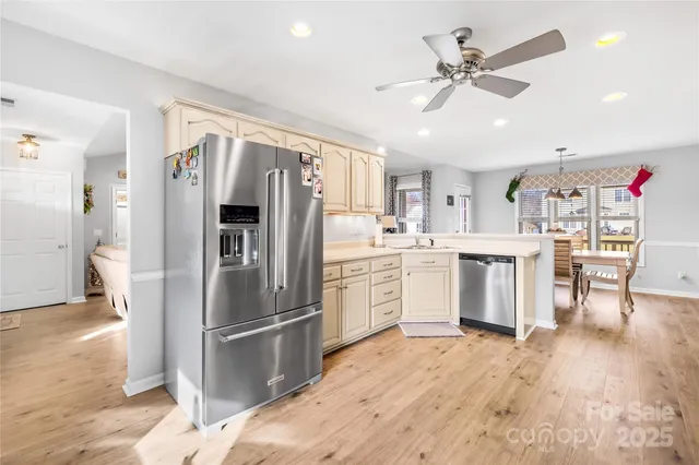 a kitchen with stainless steel appliances a refrigerator sink and cabinets