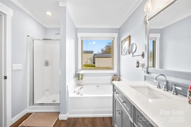 a bathroom with a tub a sink and mirrors