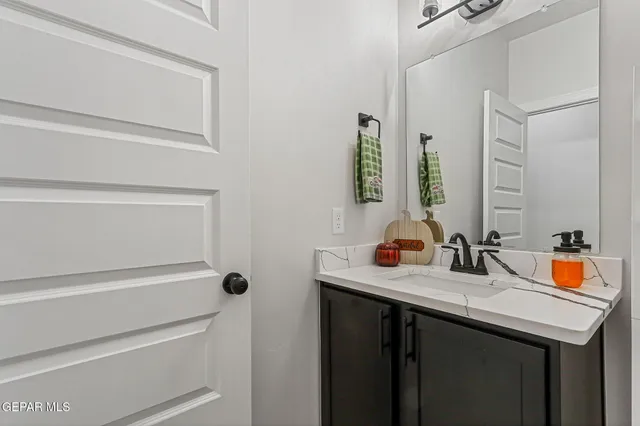 a living room with furniture a potted plant and a flat screen tv