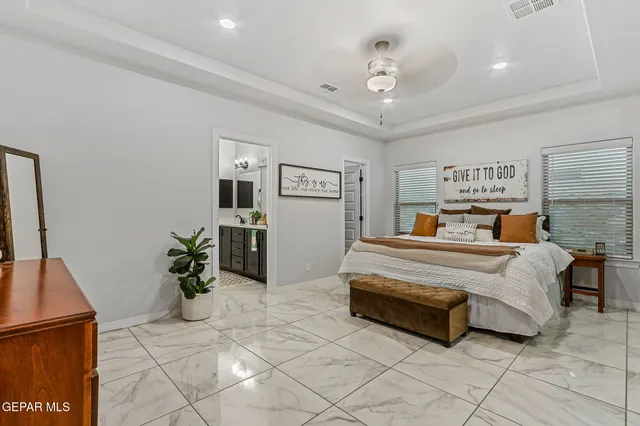 a living room with furniture rug and a potted plant