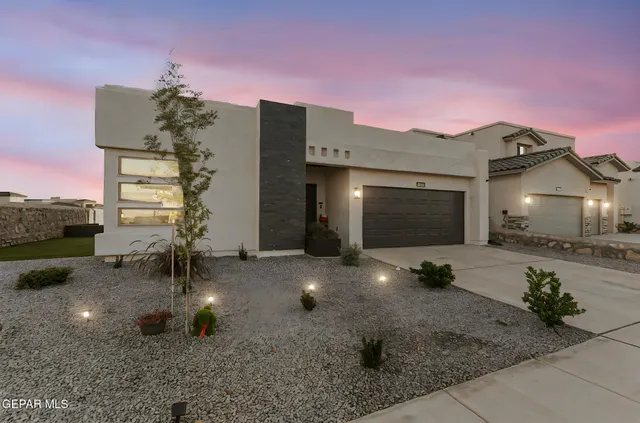 an aerial view of ocean and residential houses with outdoor space