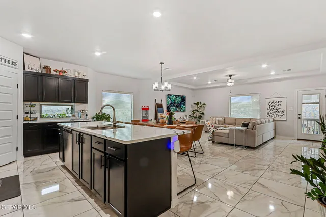 a large kitchen with a table and chairs