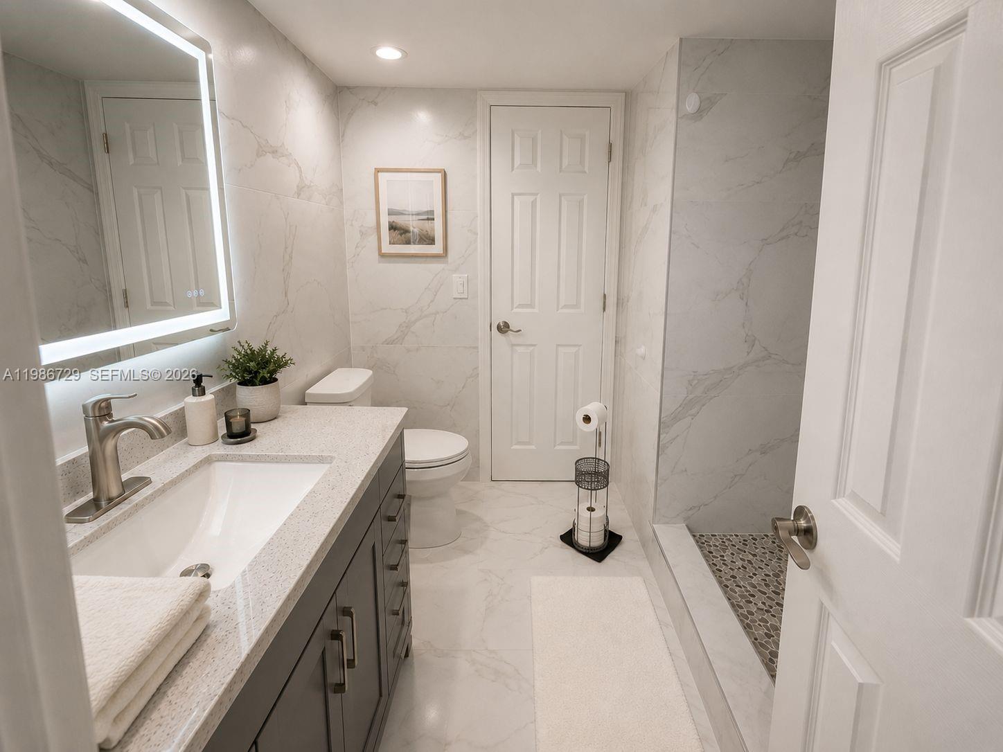 299 Northwest 52nd Terrace, Unit PHX Boca Raton, FL 33487 - Photo 4 of 16 a bathroom with a sink and a mirror