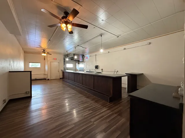 a living room with kitchen island furniture and a wooden floor