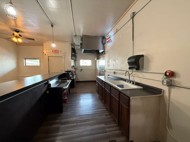 a kitchen with sink stove and refrigerator
