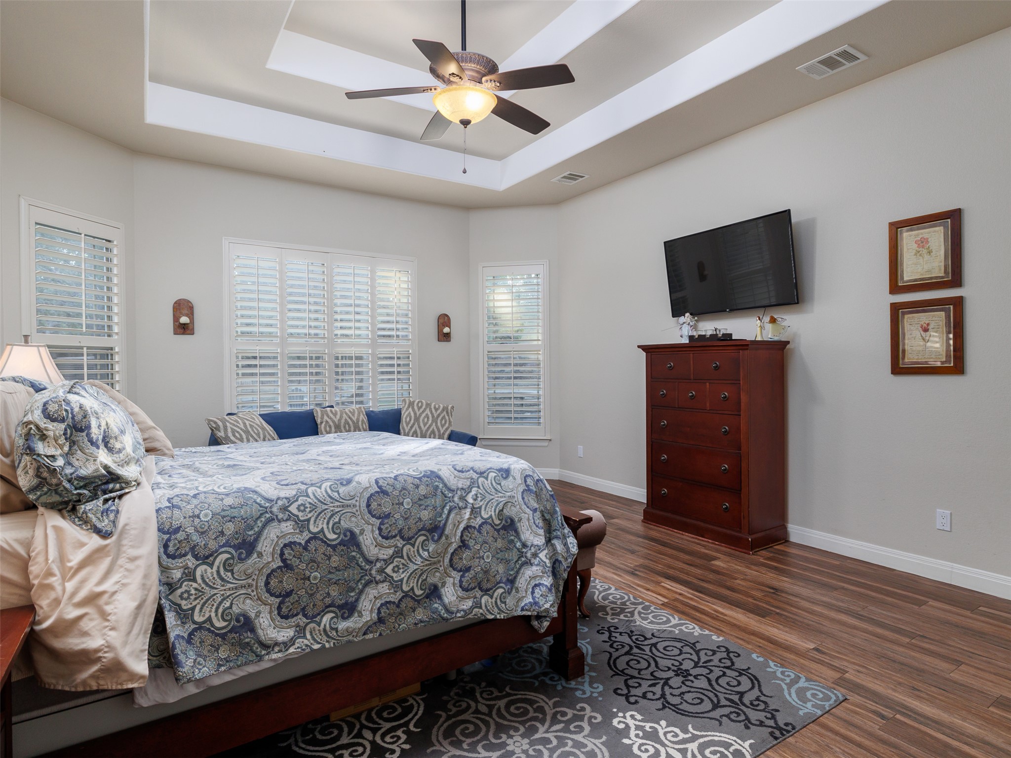 1316 Ranchers Club Lane Driftwood, TX 78619 - Photo 14 of 40 a bedroom with a bed and a flat screen tv