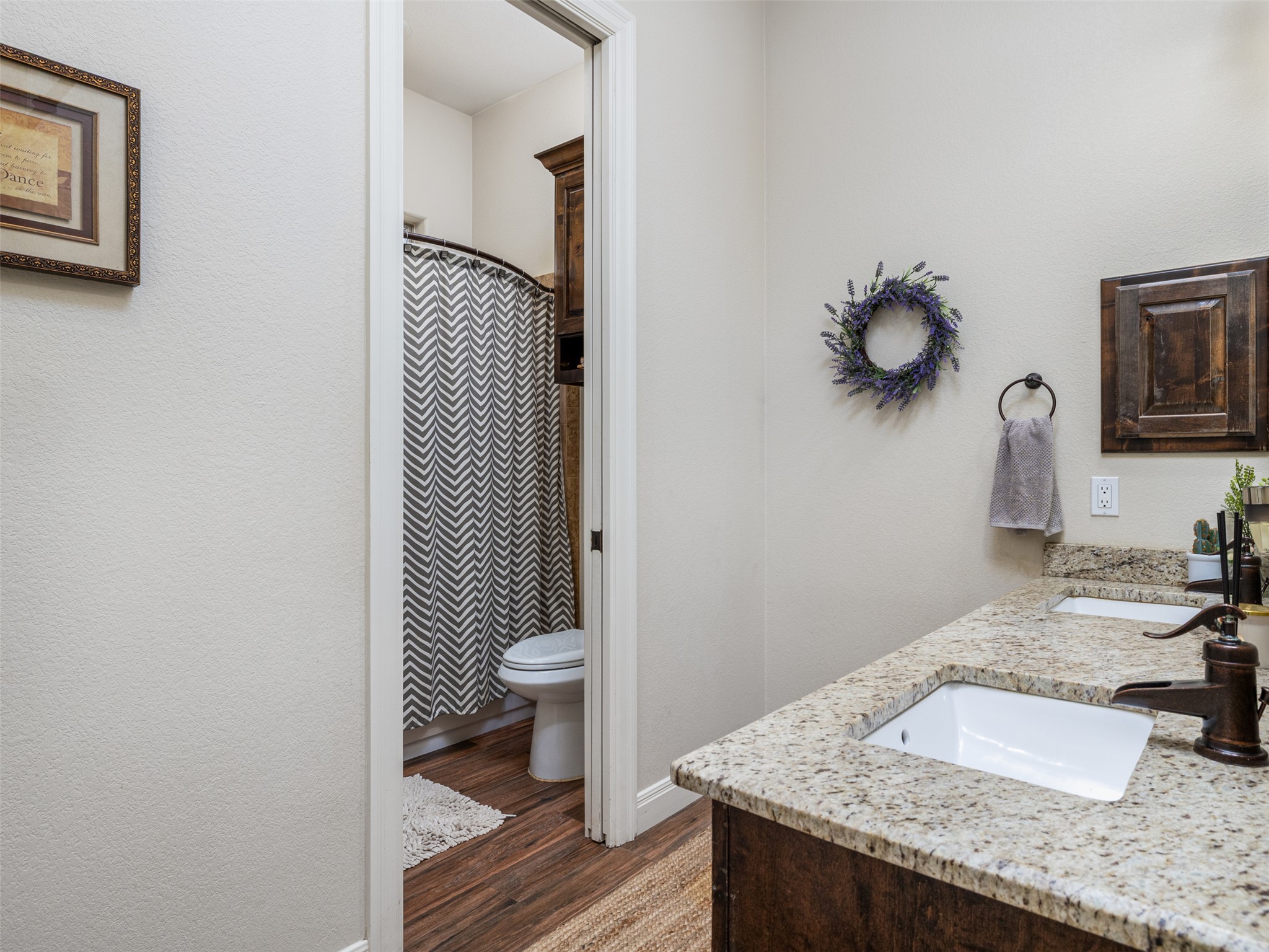 1316 Ranchers Club Lane Driftwood, TX 78619 - Photo 19 of 40 a bathroom with a granite countertop sink and a toilet