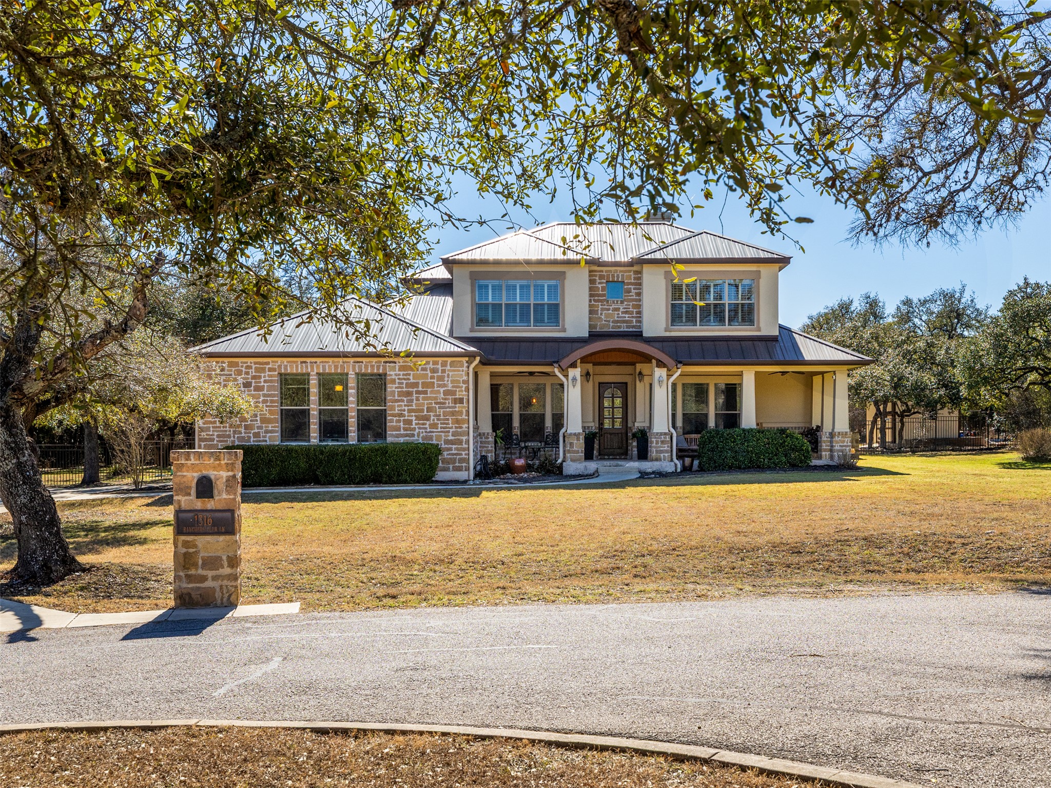 1316 Ranchers Club Lane Driftwood, TX 78619 - Photo 2 of 40 a front view of a house with a yard