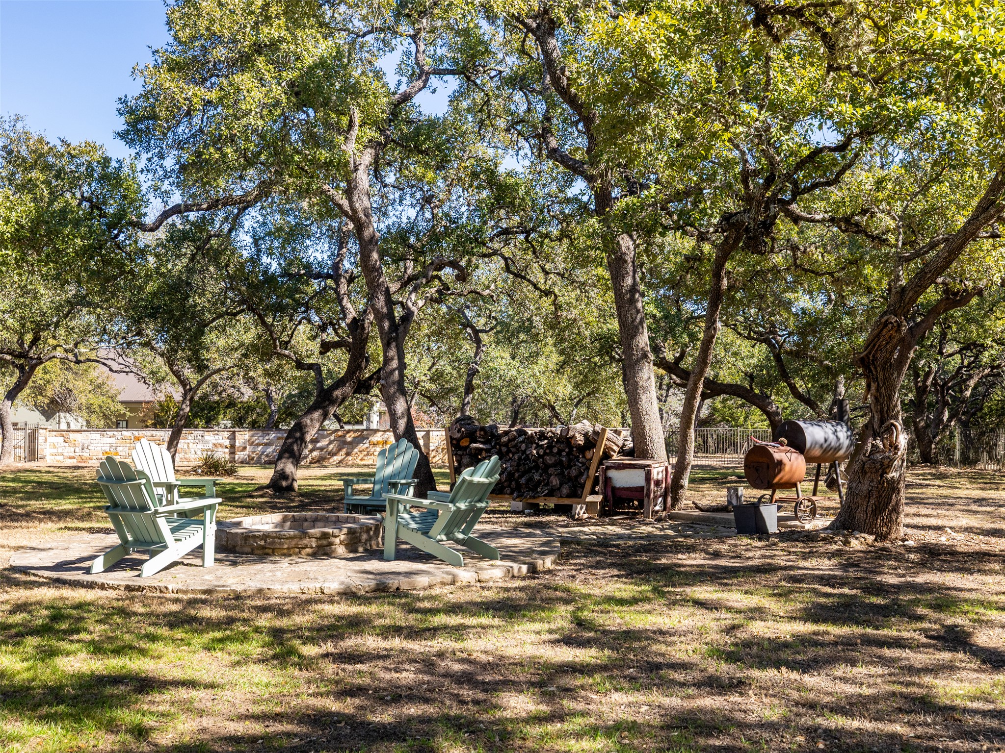 1316 Ranchers Club Lane Driftwood, TX 78619 - Photo 32 of 40 a view of a fire pit with large trees