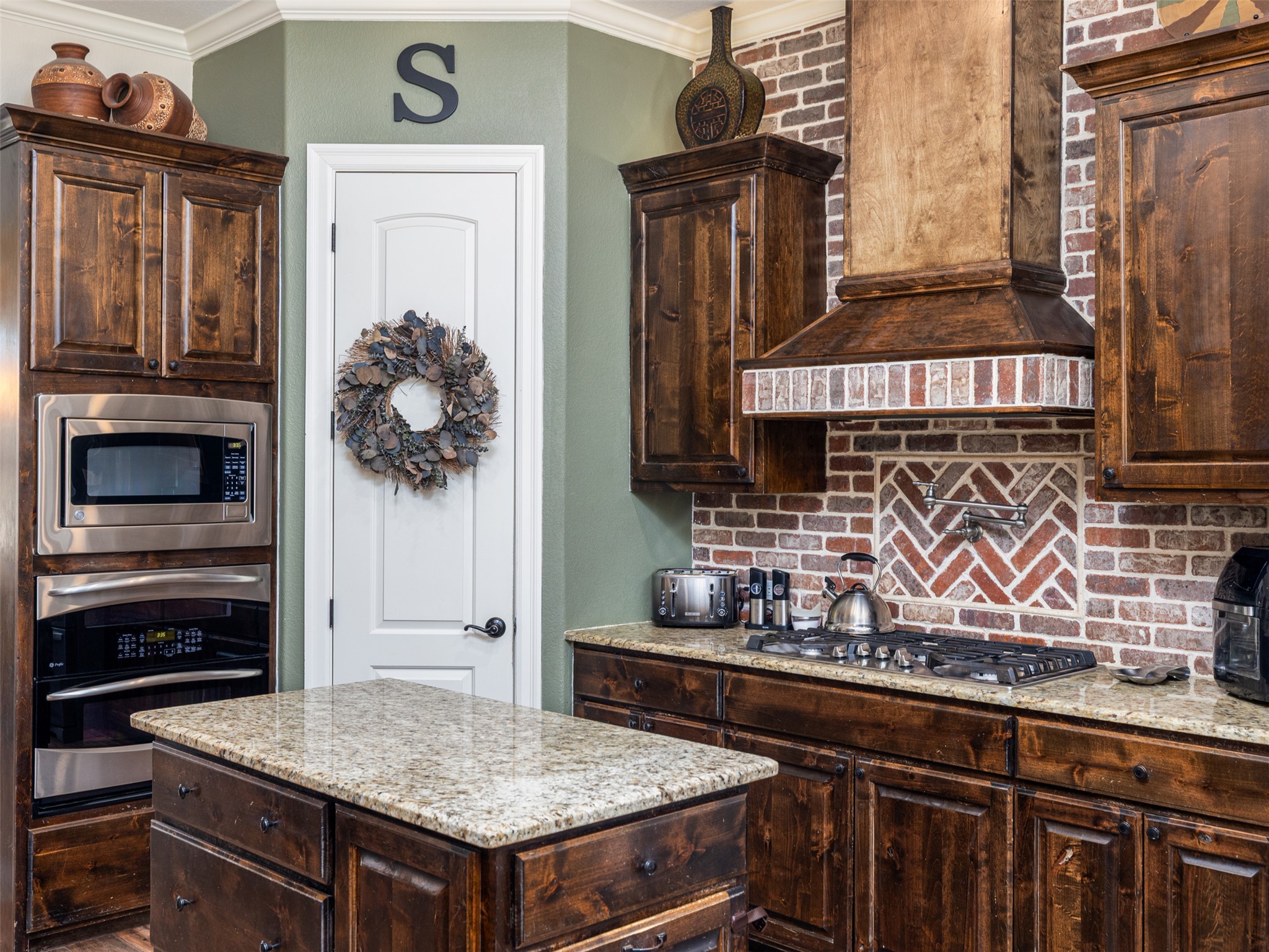 1316 Ranchers Club Lane Driftwood, TX 78619 - Photo 7 of 40 a kitchen with a stove and a microwave