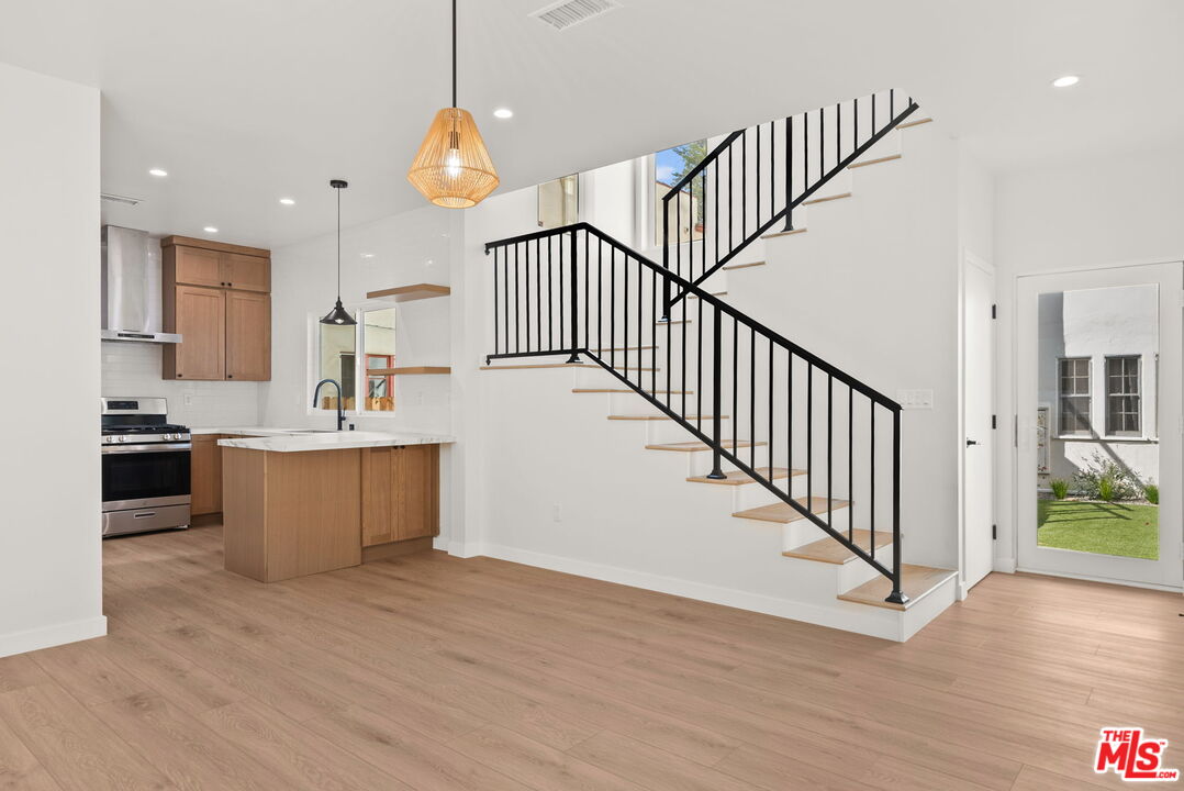 128 South Swall Drive, Unit 1/2 Los Angeles, CA 90048 - Photo 1 of 32 a view of kitchen with wooden floor and electronic appliances