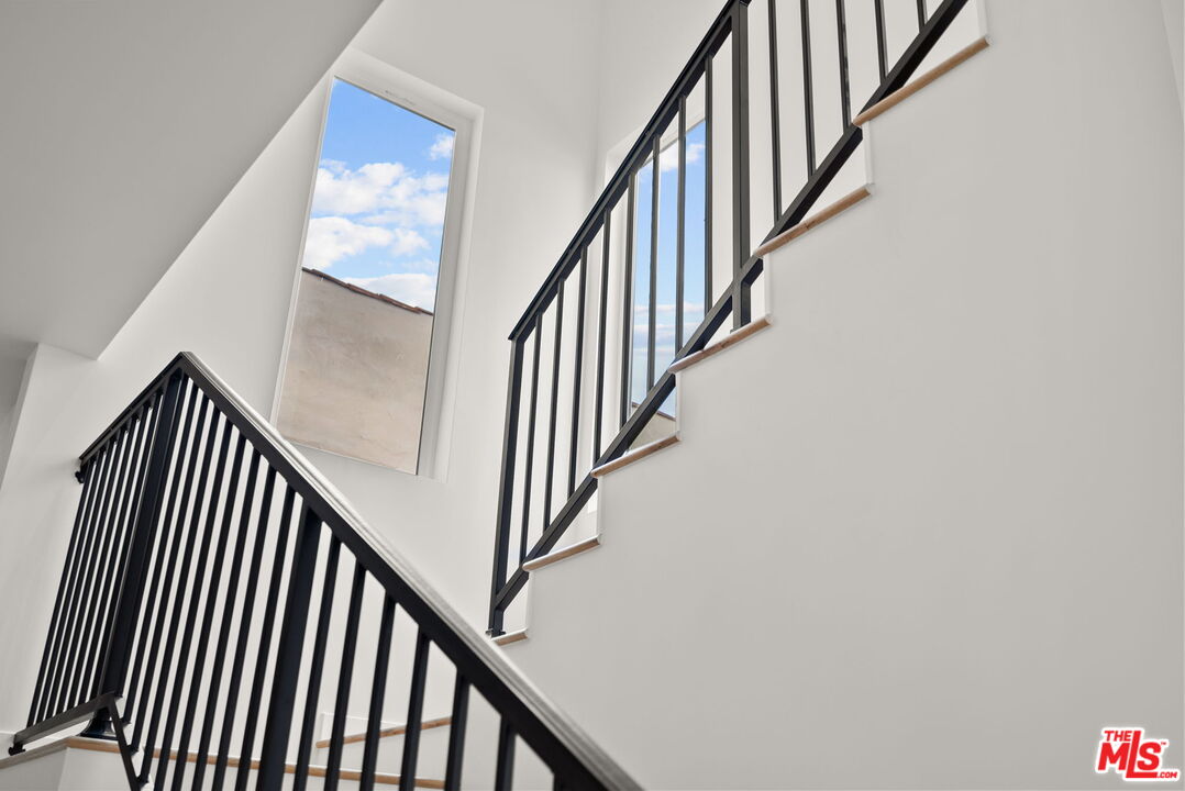128 South Swall Drive, Unit 1/2 Los Angeles, CA 90048 - Photo 12 of 32 a view of staircase with wooden floor and white walls