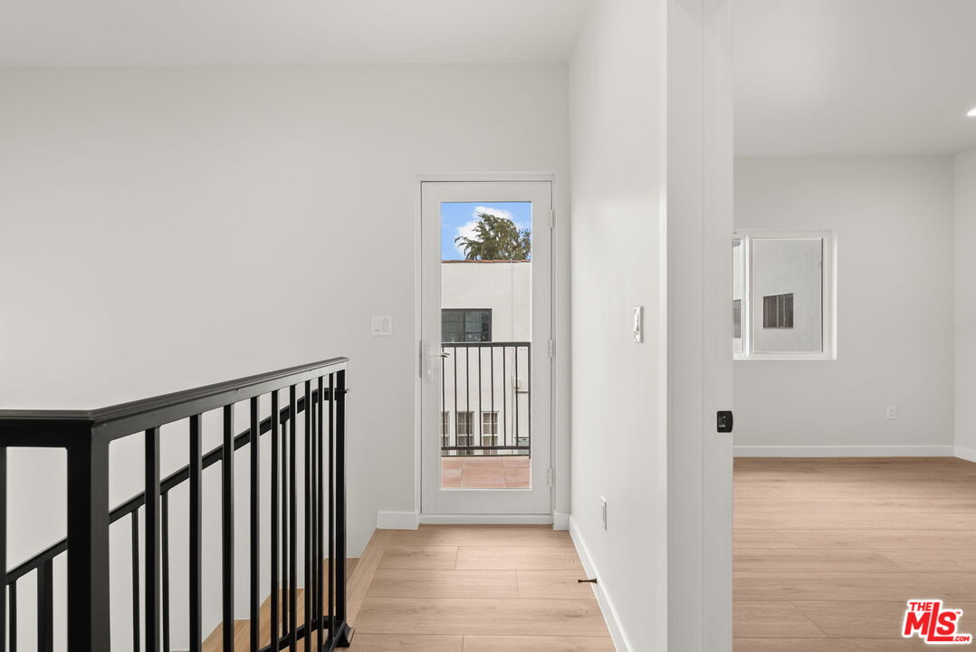 128 South Swall Drive, Unit 1/2 Los Angeles, CA 90048 - Photo 13 of 32 a view of a hallway view with wooden floor and staircase