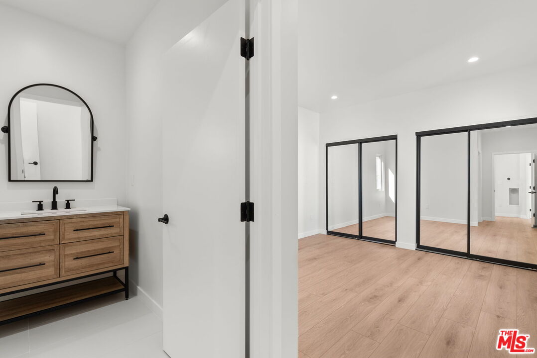128 South Swall Drive, Unit 1/2 Los Angeles, CA 90048 - Photo 18 of 32 a bathroom with a double vanity sink and mirror