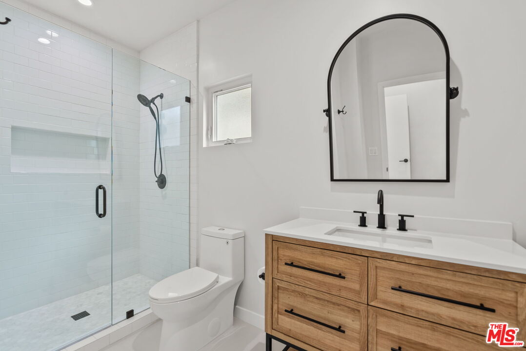 128 South Swall Drive, Unit 1/2 Los Angeles, CA 90048 - Photo 19 of 32 a bathroom with a sink toilet and shower