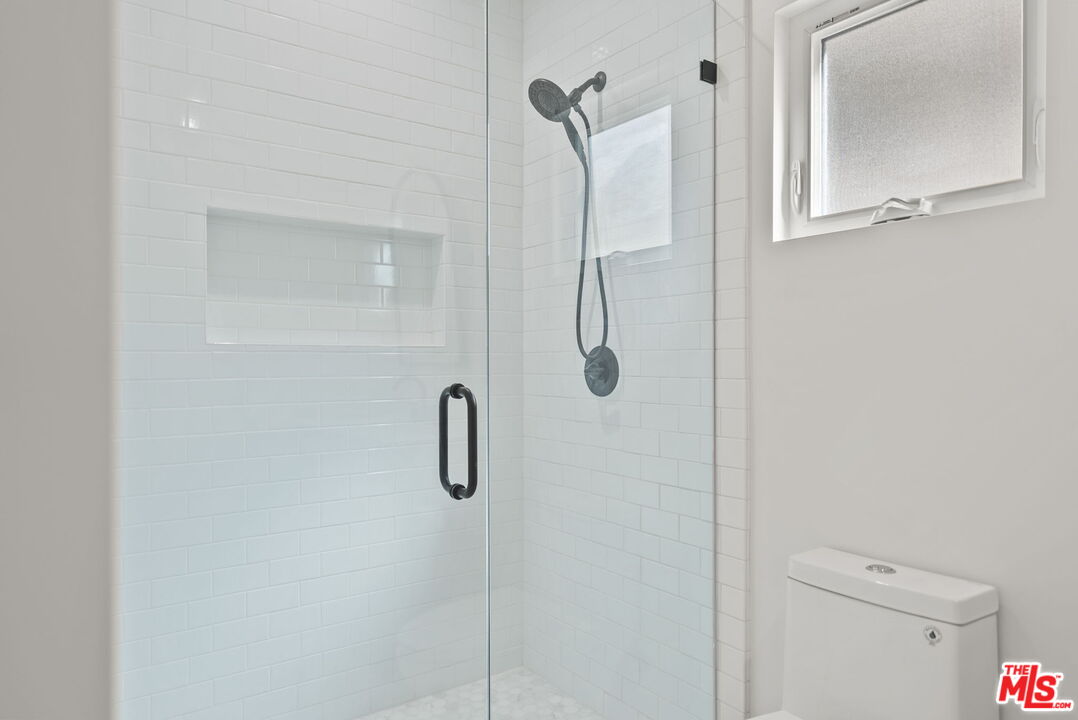128 South Swall Drive, Unit 1/2 Los Angeles, CA 90048 - Photo 20 of 32 a bathroom with a shower and a toilet